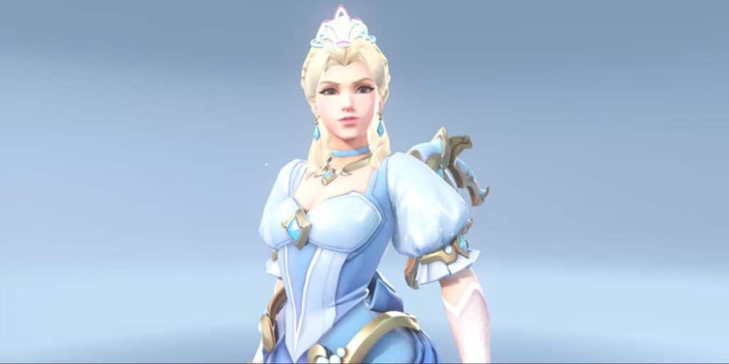 Royal Princess Mercy wearing a light blue, elegant gown with silver and white accents, styled with jewelry and a tiara against a soft background.
