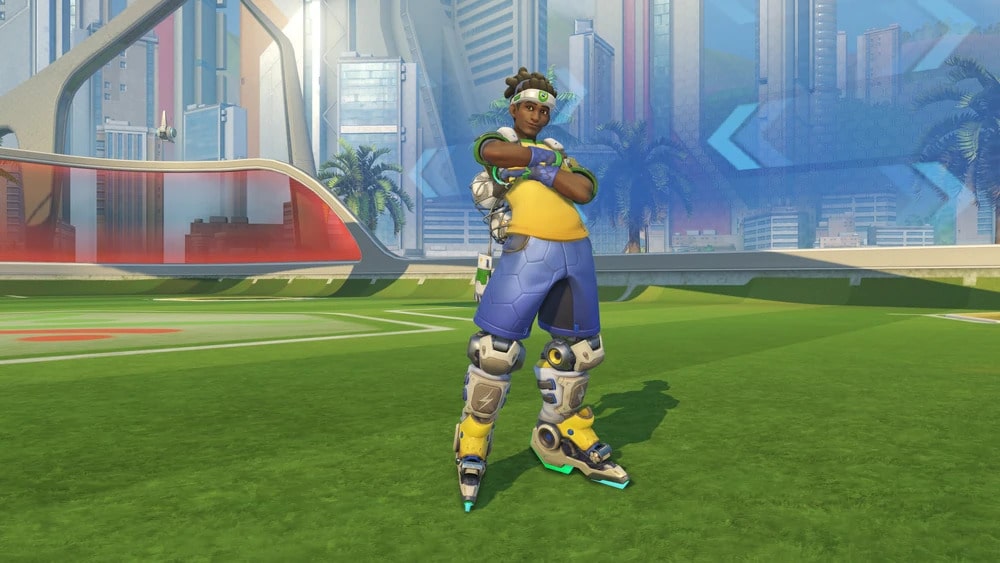 Lucio from Overwatch in sporty attire stands confidently on a green field, surrounded by a vibrant urban landscape with palm trees.