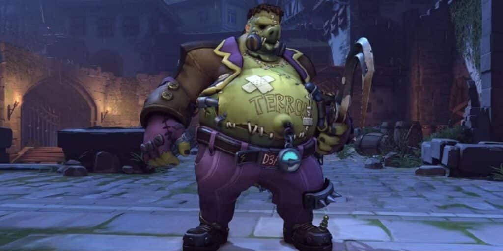 Roadhog in torn, purple attire stands in a dim, eerie courtyard