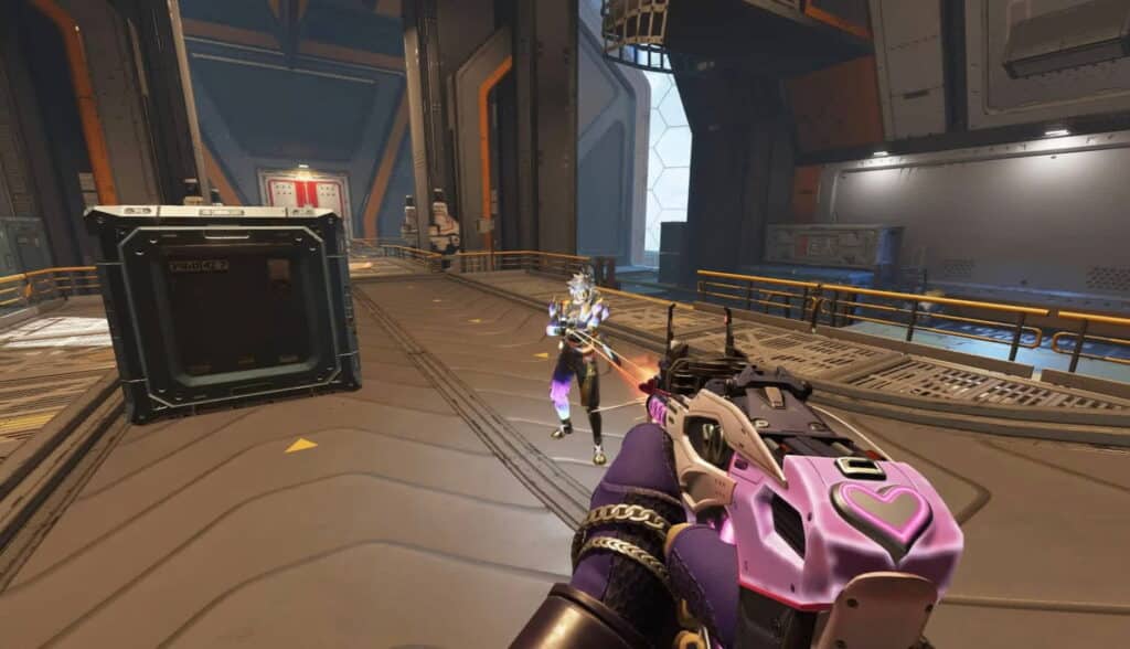 A player aims at an enemy in a futuristic arena during an Apex Legends match